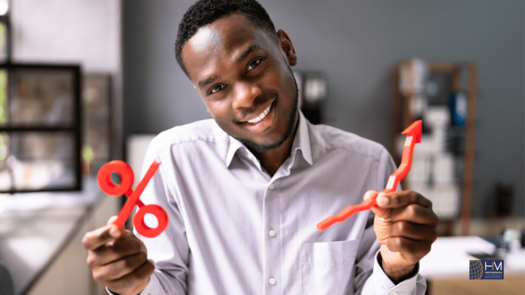 Smiling man holding percentage and arrow signs.