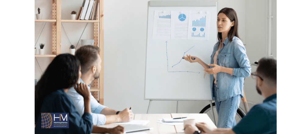 Woman presenting growth chart to colleagues.