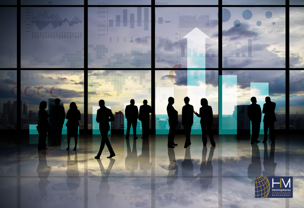 Silhouettes of businesspeople in front of charts.