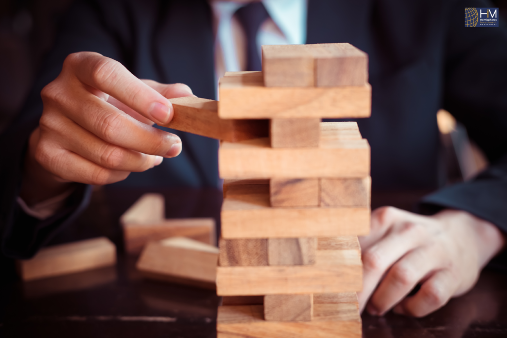 Person playing wooden block stacking game.